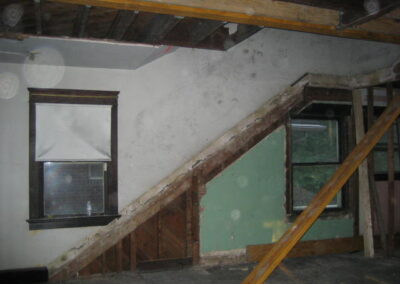 The former stair to the Upper Level Duplex Unit was removed, along with the wall that separated it from the Lower Level Duplex Unit. It was replaced by a new stair that meets code. This shows the conditions of the former stair during demolition, prior to new construction.